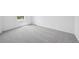 Bright bedroom features neutral carpet, white walls, baseboards, and a window at 24707 E 40Th Ave, Aurora, CO 80019