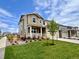 Beautiful two-story home with a spacious lawn, a charming front porch, and a well-manicured garden at 24707 E 40Th Ave, Aurora, CO 80019