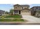 Two-story home featuring a two car garage, front porch and nicely manicured lawn at 24707 E 40Th Ave, Aurora, CO 80019