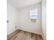 Bright laundry room has wood style floors and a window with light streaming in at 24707 E 40Th Ave, Aurora, CO 80019