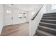 Bright living room featuring gray carpet on stairs, wood floors and front door views at 24707 E 40Th Ave, Aurora, CO 80019