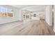 Open-concept living space featuring wood floors, bright lighting, and sliding glass doors at 24707 E 40Th Ave, Aurora, CO 80019