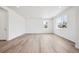 Large open living room featuring bright natural light and beautiful wood floors at 24707 E 40Th Ave, Aurora, CO 80019