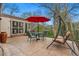 Relaxing back patio with an umbrella-covered table, chairs, and swing set for outdoor enjoyment at 6305 W 6Th Ave # C17, Lakewood, CO 80214