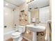 Bathroom with a sink, a patterned wall, and a shower-tub combination with a white shower curtain at 6305 W 6Th Ave # C17, Lakewood, CO 80214