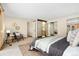 Bedroom with sitting area, view of the bathroom, closet with mirrored doors, and neutral colored carpet at 6305 W 6Th Ave # C17, Lakewood, CO 80214