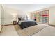 Bright bedroom featuring a walkout to private deck with outdoor furniture and updated interior design at 6305 W 6Th Ave # C17, Lakewood, CO 80214
