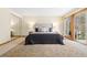 A spacious bedroom features an area rug, soft lighting, and a sliding door to the outside at 6305 W 6Th Ave # C17, Lakewood, CO 80214