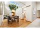 Elegant dining area with a modern table set, high ceilings, and a unique indoor tree feature at 6305 W 6Th Ave # C17, Lakewood, CO 80214