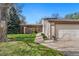 Charming home featuring a landscaped front yard, covered entry, and an attached two-car garage at 6305 W 6Th Ave # C17, Lakewood, CO 80214