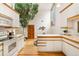 Functional kitchen featuring modern appliances, bright counter tops and unique indoor tree feature at 6305 W 6Th Ave # C17, Lakewood, CO 80214