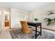 Office with neutral walls, a black desk, and woven chair with a view of the bathroom at 6305 W 6Th Ave # C17, Lakewood, CO 80214