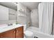 Updated bathroom with tub, shower, tiled wall, and wood vanity at 2850 Roosevelt, Thornton, CO 80229