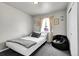 A bedroom with carpet floors, light colored walls, bean bag chair, and window at 2850 Roosevelt, Thornton, CO 80229