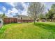 Quaint home featuring a lush green lawn and a wood fence, providing privacy and a touch of rustic charm at 2850 Roosevelt, Thornton, CO 80229