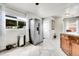 A kitchen with stainless steel refrigerator, tile flooring, and view of backyard at 2850 Roosevelt, Thornton, CO 80229