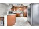 Kitchen featuring stainless appliances, granite counters, and tiled flooring at 2850 Roosevelt, Thornton, CO 80229