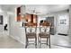 Modern kitchen with stainless steel appliances, breakfast bar seating, and contemporary decor at 2850 Roosevelt, Thornton, CO 80229