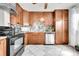 A kitchen with stainless steel appliances, wood cabinets, and tile backsplash at 2850 Roosevelt, Thornton, CO 80229