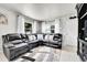 Comfortable living room with a large leather sofa, neutral decor, and an inviting, airy feel at 2850 Roosevelt, Thornton, CO 80229
