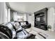 Cozy living space with a large leather couch, entertainment center, and bright natural light at 2850 Roosevelt, Thornton, CO 80229