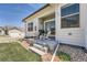 Back patio with rocking chairs and barbecue overlooking the lawn at 11905 Sea Oats St, Parker, CO 80138