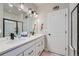 Modern bathroom with double sinks, contemporary lighting, and a glass-enclosed shower at 11905 Sea Oats St, Parker, CO 80138