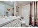 Bright bathroom with a white vanity, framed mirror, and a shower-tub combination at 11905 Sea Oats St, Parker, CO 80138