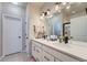 Well-lit bathroom boasts dual sinks, white cabinets, and sleek, modern fixtures at 11905 Sea Oats St, Parker, CO 80138