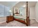 Charming bedroom with a four-poster bed, bedside table and great natural light at 11905 Sea Oats St, Parker, CO 80138