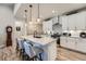 Modern kitchen boasts stainless steel appliances, an island with seating, and ample counter space at 11905 Sea Oats St, Parker, CO 80138