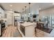 Modern kitchen featuring a center island, stainless steel appliances, and seamless flow to the dining and living spaces at 11905 Sea Oats St, Parker, CO 80138