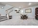 Open finished basement living room area with staircase and dining table at 11905 Sea Oats St, Parker, CO 80138