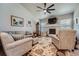 Cozy living room boasts a fireplace, ceiling fan, and comfortable seating for relaxation and entertainment at 11905 Sea Oats St, Parker, CO 80138