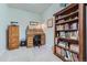 Home office with a wooden roll-top desk, built-in bookcase, and ample storage at 11905 Sea Oats St, Parker, CO 80138