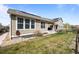 Wide shot of backyard with solar panels visible on roof of home at 827 Sundance Ln, Erie, CO 80516