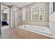 Spacious bathroom featuring a soaking tub and glass shower with tile surround at 827 Sundance Ln, Erie, CO 80516