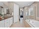 Luxurious bathroom with double vanity sinks, a soaking tub, and separate glass shower at 827 Sundance Ln, Erie, CO 80516