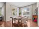 Cozy dining area with a modern wooden table, a sliding glass door, and natural lighting at 827 Sundance Ln, Erie, CO 80516