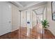 Inviting foyer boasting gleaming hardwood floors and an open view of the living space at 827 Sundance Ln, Erie, CO 80516