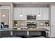 Modern kitchen featuring stainless appliances, stone countertops, and white cabinets at 827 Sundance Ln, Erie, CO 80516