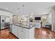Open-concept kitchen with stainless steel appliances and view of fireplace and living room at 827 Sundance Ln, Erie, CO 80516