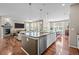 Open-concept kitchen and living room area with fireplace, hardwood floors, and dining table at 827 Sundance Ln, Erie, CO 80516