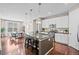 Modern kitchen featuring an island with barstool seating, stainless appliances, and pendant lights at 827 Sundance Ln, Erie, CO 80516