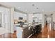 Modern kitchen featuring an island with barstool seating, stainless appliances, and pendant lights at 827 Sundance Ln, Erie, CO 80516
