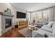 Inviting living room with a cozy fireplace, lots of natural light, and hardwood floors at 827 Sundance Ln, Erie, CO 80516