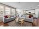 Spacious living room with hardwood floors flowing into an eat-in kitchen and large windows at 827 Sundance Ln, Erie, CO 80516