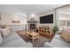 Comfortable living room featuring a stone fireplace, hardwood floors, and modern decor at 827 Sundance Ln, Erie, CO 80516