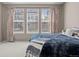 Comfortable main bedroom with soft carpet and lots of natural light from the many windows at 827 Sundance Ln, Erie, CO 80516