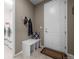 Convenient mud room area with hooks, a bench, and easy access to laundry and the door at 827 Sundance Ln, Erie, CO 80516
